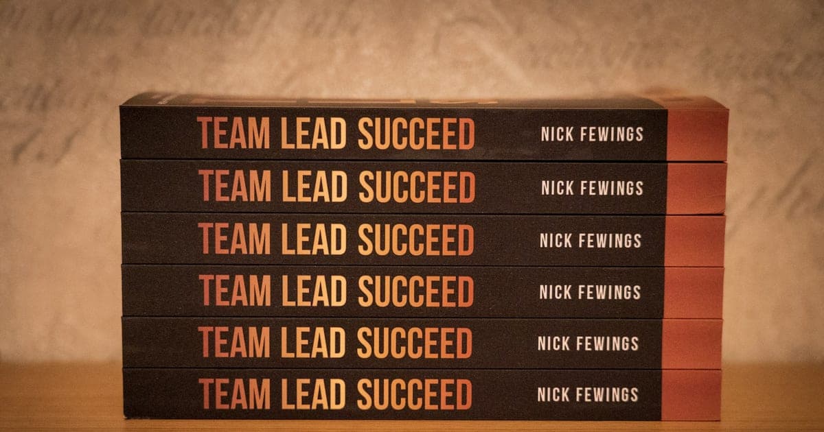 Business books neatly stacked on top of each other.