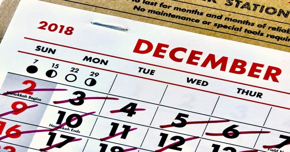 A calendar with multiple meeting blocks crossed out in red, leaving open white space